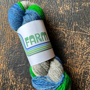 Multicolored yarn skein with a label on a textured surface